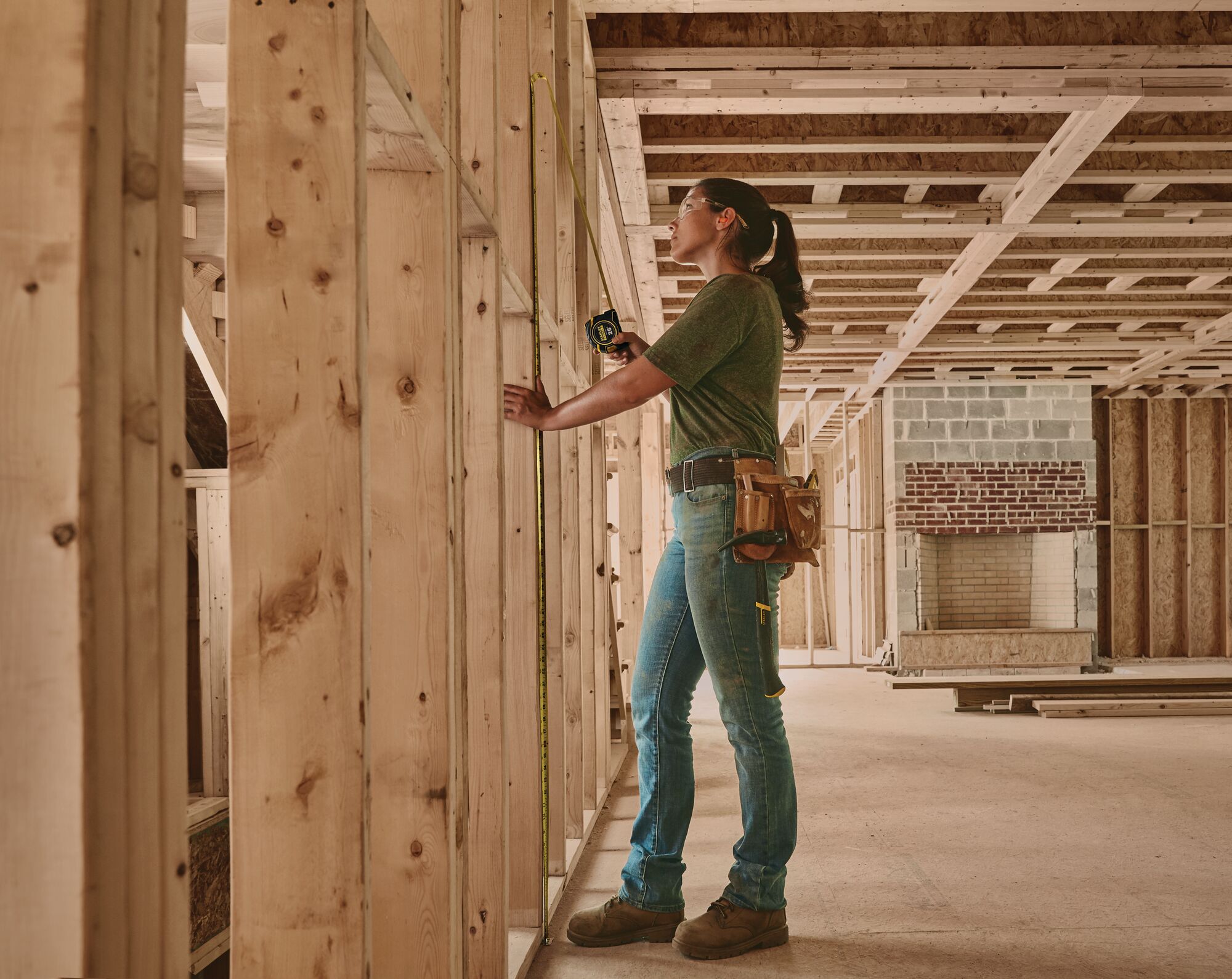 25 feet fatmax auto lock tape being used to measure a wooden panel.